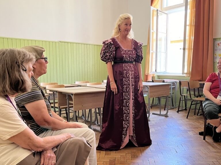 4th Convo Sonja Fischer workshop - a woman in medieval dress presenting to a small audience