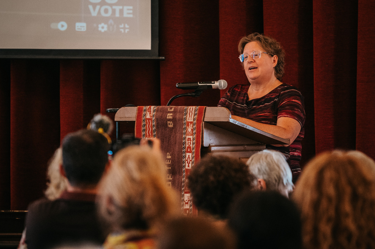Dr Maureen Porter - woman wearing glasses medium length light brown hair speaking from podium
