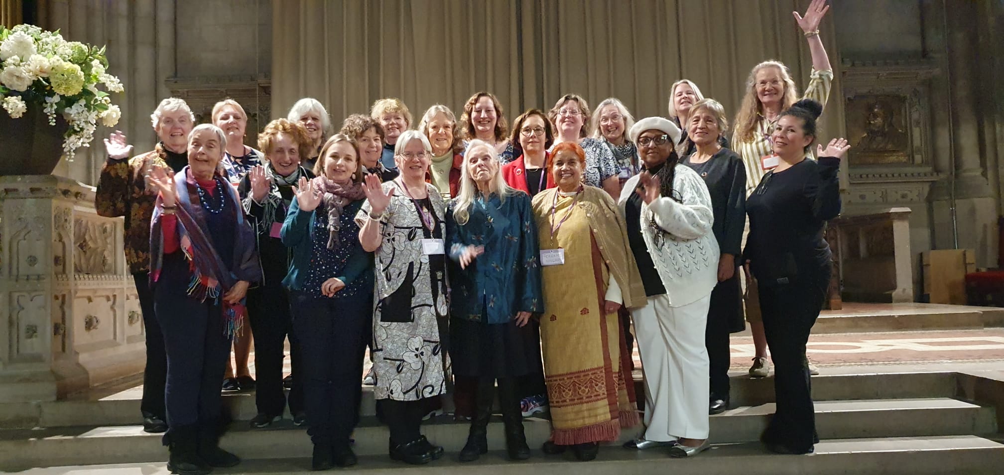 ICUUW Spring Seminar - large group of women on steps smiling, one waving at camera