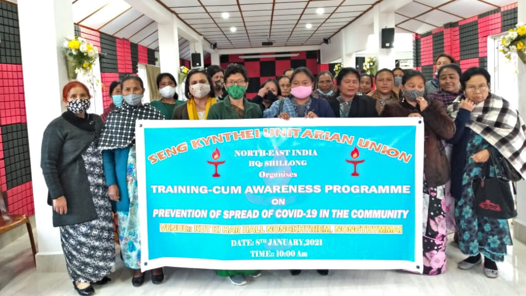 Seng Kynthei Covid-19 program: group of women standing behind a blue banner