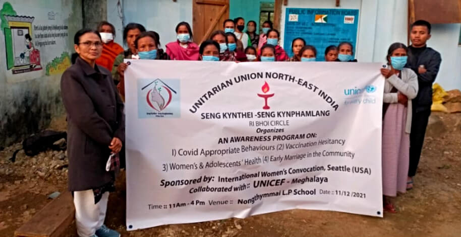 Seng Kynthei: group of people standing behind a white banner