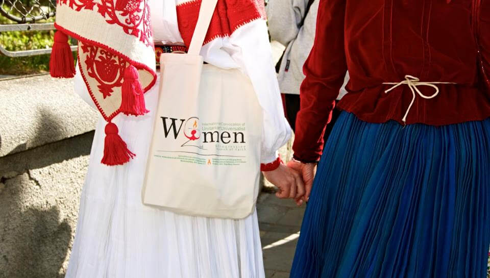 Women at the Second (2012) Convocation, Târgu-Mureș (Marosvásárhely), Transylvania, Romania - view is behind 2 women holding hands - totebag with logo