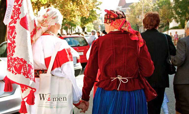 UNOSZ women at the 2012 Convocation - two women outdoors in traditional dresses and headscarves, walking away from the camera